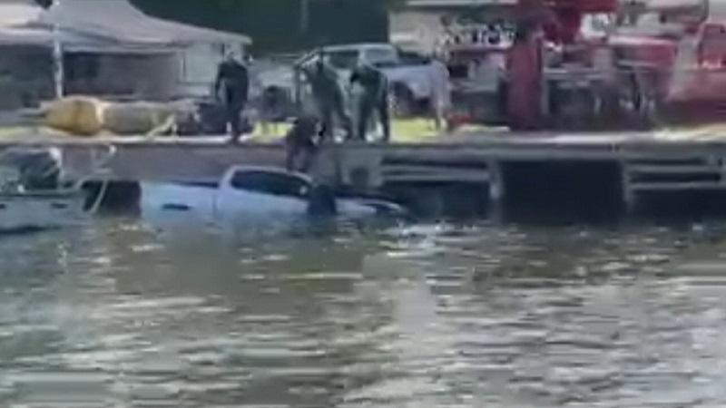 A man and his nephew rescue a woman from truck in a river