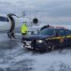 A woman is transported by troopers for a heart transplant amid a snowfall