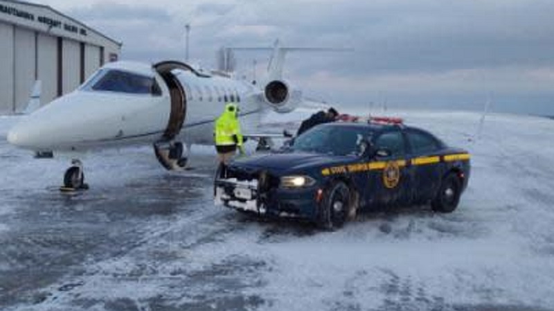 A woman is transported by troopers for a heart transplant amid a snowfall