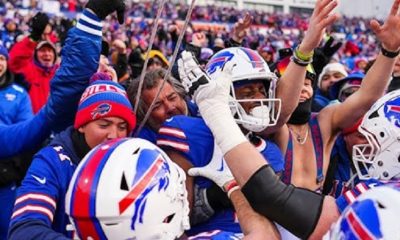 As Buffalo defeats the Broncos in the wild-card game, Bills supporters celebrate joyfully at Bar Bill East