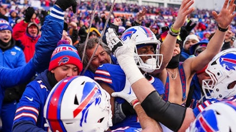 As Buffalo defeats the Broncos in the wild-card game, Bills supporters celebrate joyfully at Bar Bill East