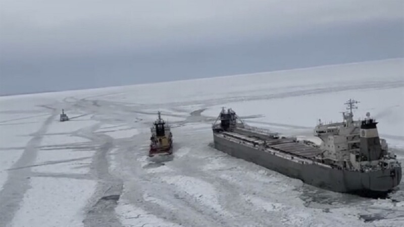 After being released from the ice on frozen Lake Erie, a freighter is seen moving